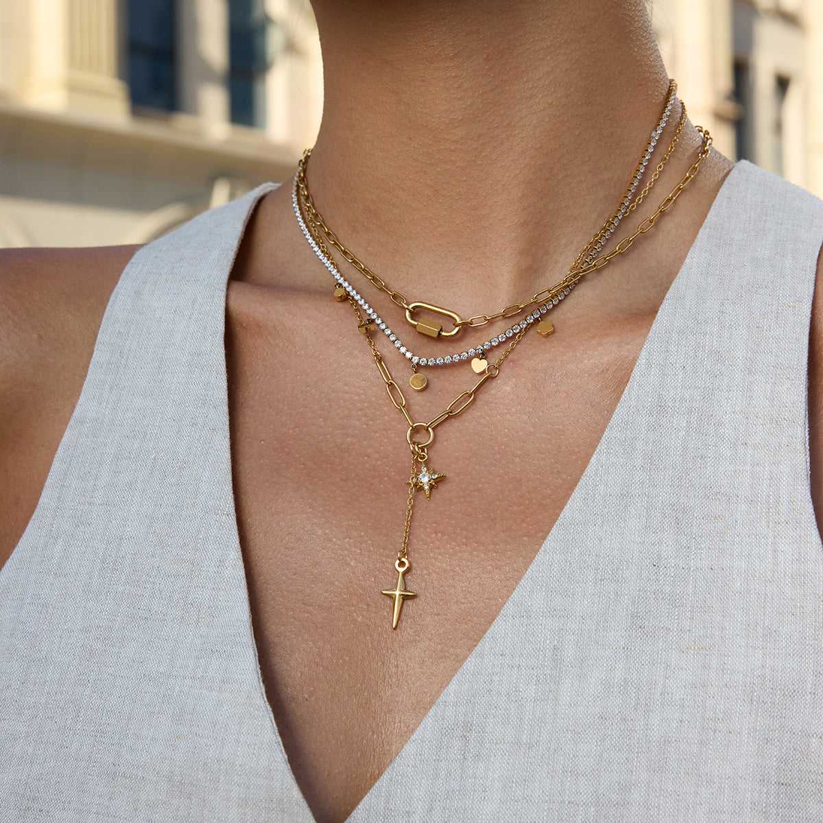 Gold paperclip chain necklace with crystal north star and gold dagger cross charms — waterproof hypoallergenic celestial statement jewelry