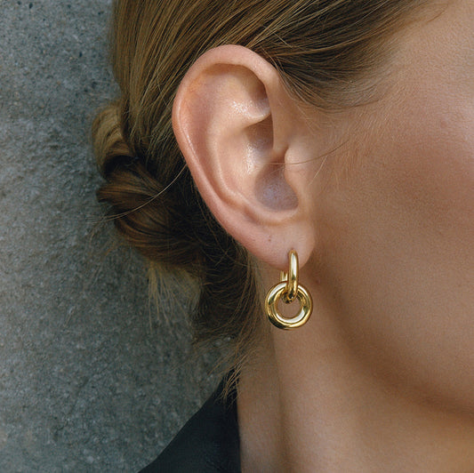 Chunky interlocked double hoop earrings in gold and two-tone gold silver on white background