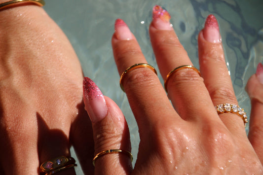 Trio of minimalist gold-plated stainless-steel rings with subtle color and sparkle, perfect for stacking or wearing solo.
