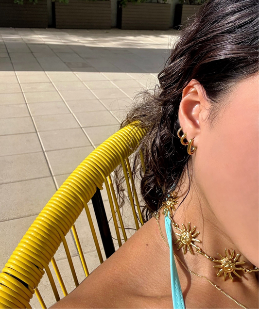 Set of six gold hoop earrings including U-shaped, round, and pavé crystal designs