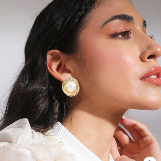 Gold swirl earrings with lustrous pearls, blending classic elegance and modern style