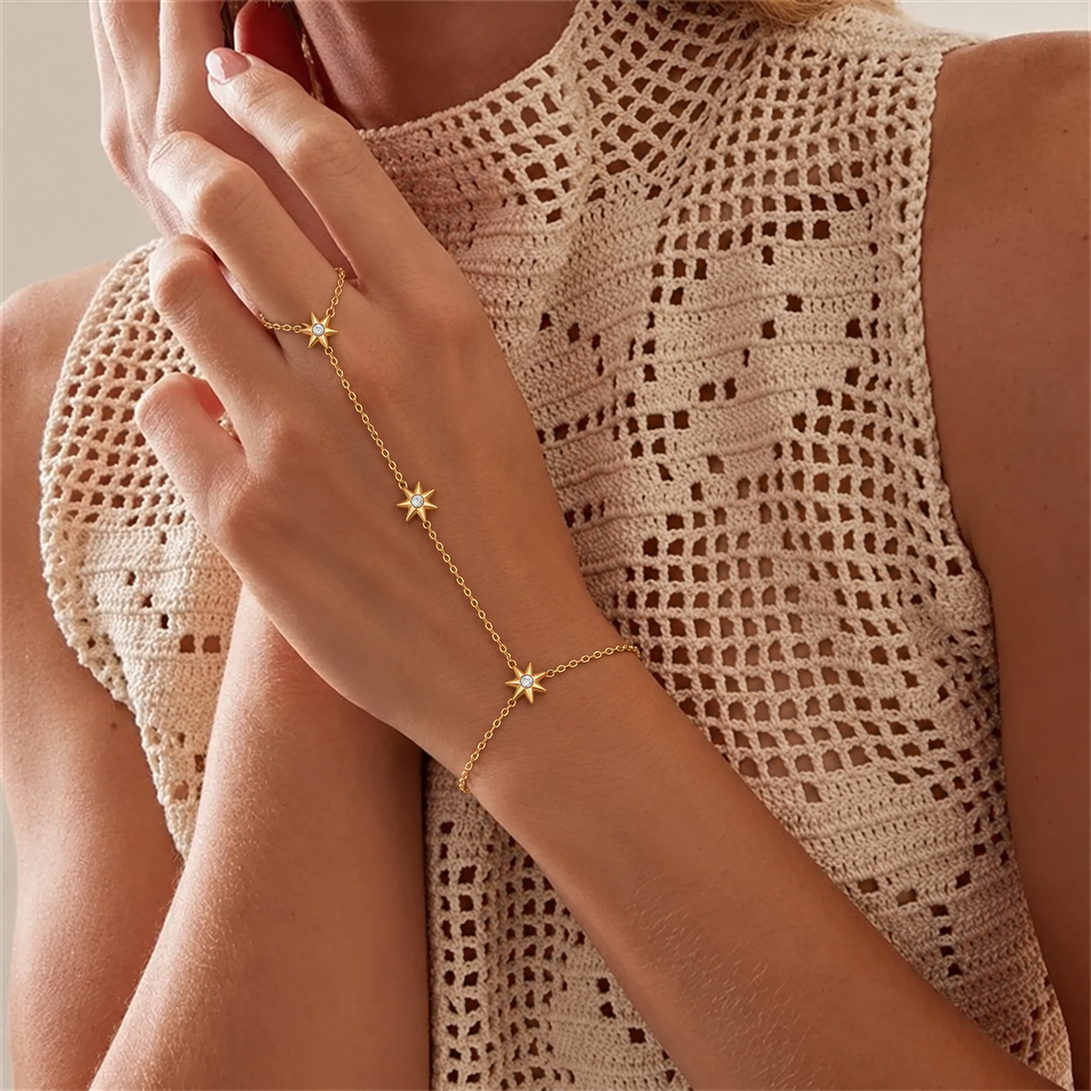 A delicate gold chain anklet featuring three small starburst charms, each adorned with a clear crystal, displayed on a clean white background.
