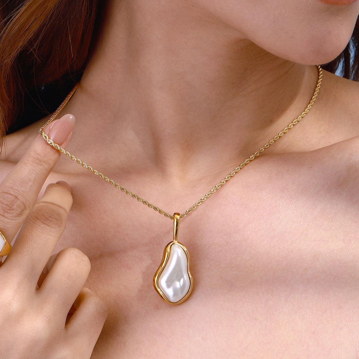 Amayah Jewelry Camille Pearl Pendant Necklace — baroque pearl in open gold frame bezel on twisted rope chain, white background