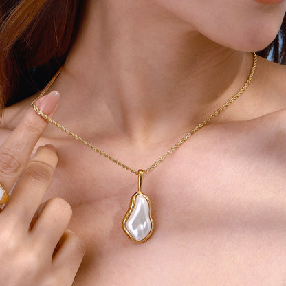 Amayah Jewelry Camille Pearl Pendant Necklace — baroque pearl in open gold frame bezel on twisted rope chain, white background