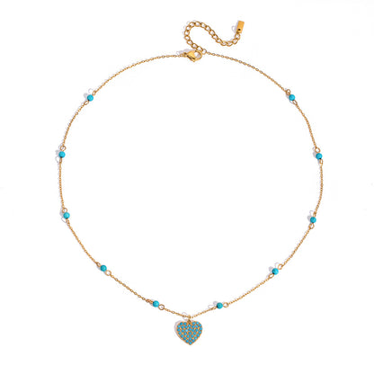Turquoise pavé heart pendant necklace on delicate gold chain, worn layered with beaded necklaces