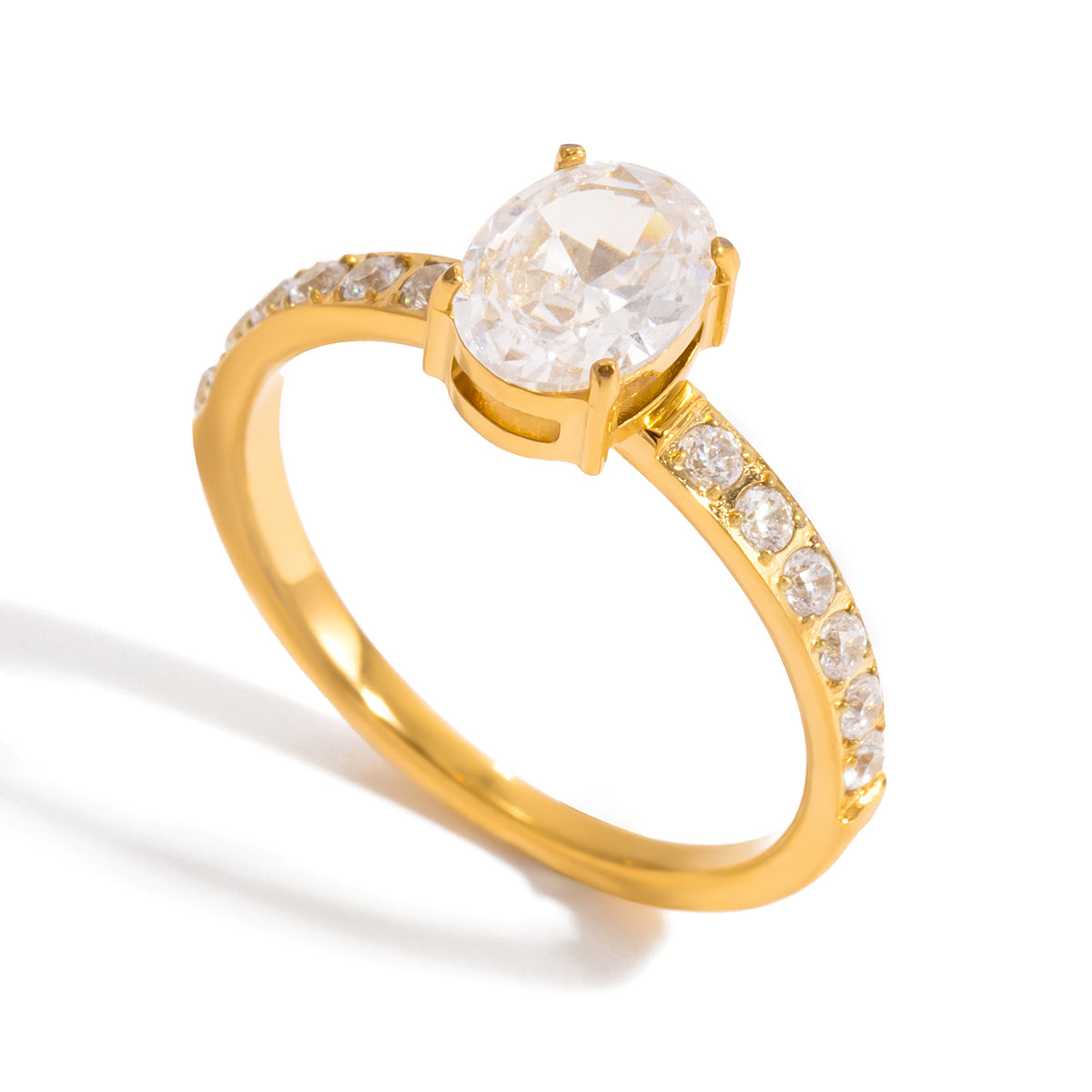 Gold ring with an oval cut clear crystal center stone and pave crystal band