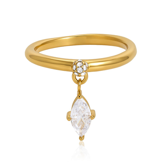 A gold ring with a polished band, a small cluster of clear stones at the top, and a dangling marquise-cut clear gemstone, shown on a white background.