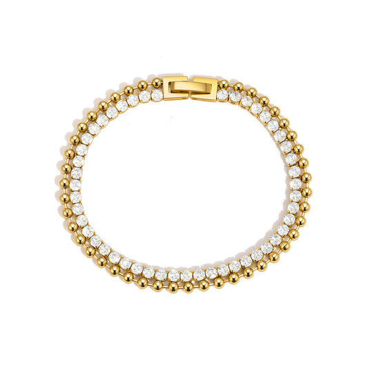 Gold and white beaded bracelet on a white background