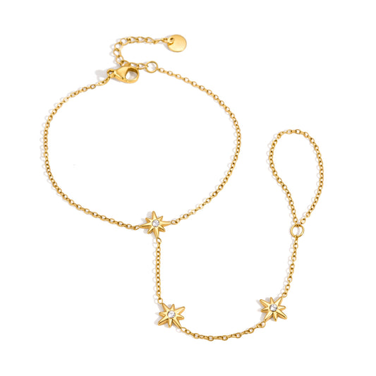 A delicate gold chain anklet featuring three small starburst charms, each adorned with a clear crystal, displayed on a clean white background.