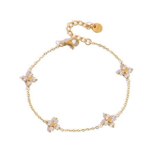 Gold bracelet with butterfly-shaped charms on a white background