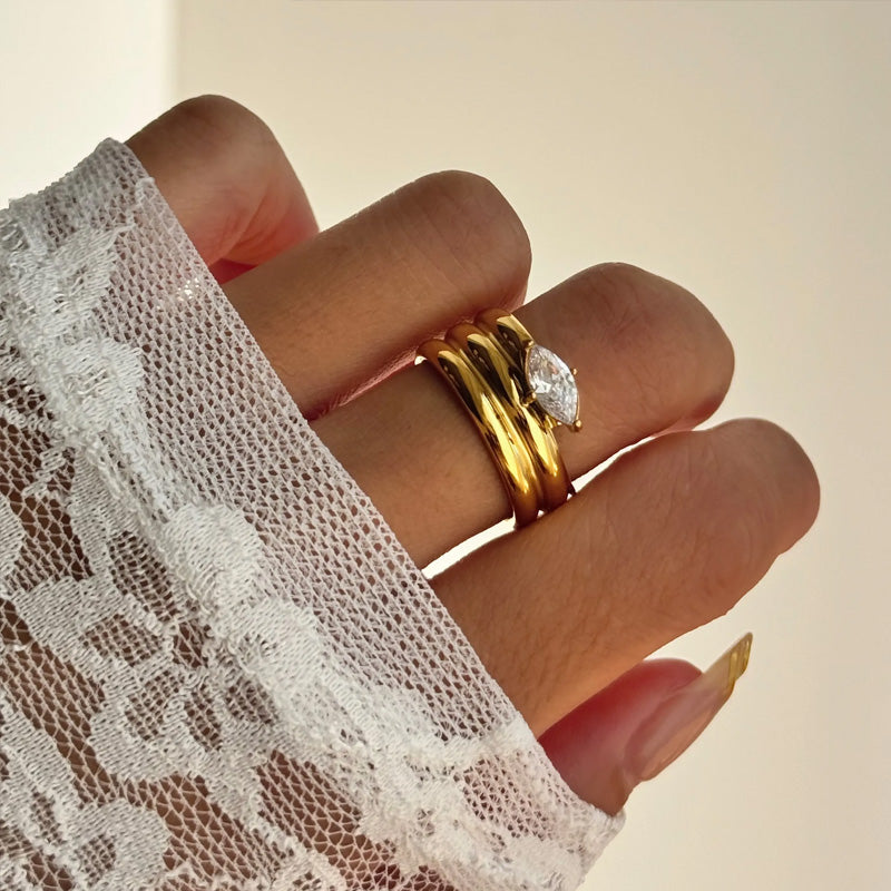 Three stackable gold band ring set with oversized prong set pear cut crystal centerstone — waterproof hypoallergenic bridal inspired statement ring
