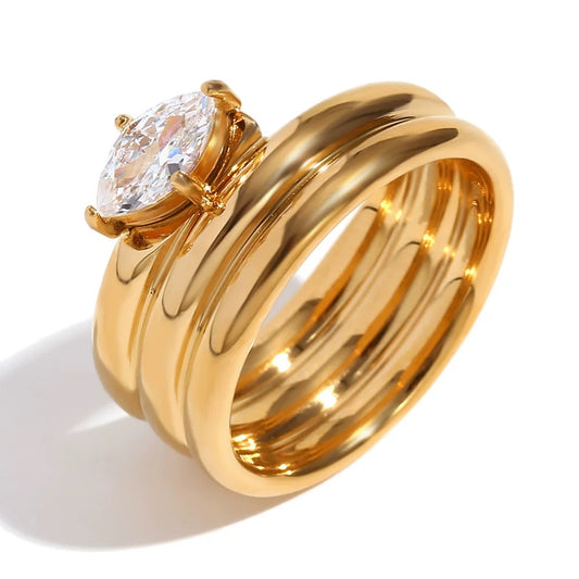 Three stackable gold band ring set with oversized prong set pear cut crystal centerstone — waterproof hypoallergenic bridal inspired statement ring
