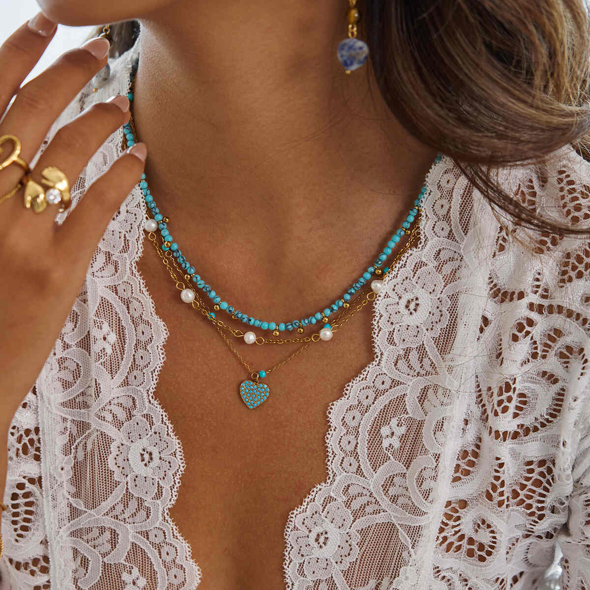 Turquoise pavé heart pendant necklace on delicate gold chain, worn layered with beaded necklaces