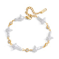 Amayah Jewelry Pearl Cross Bracelet — cross shaped baroque pearls alternating with bezel crystal stations on gold chain
