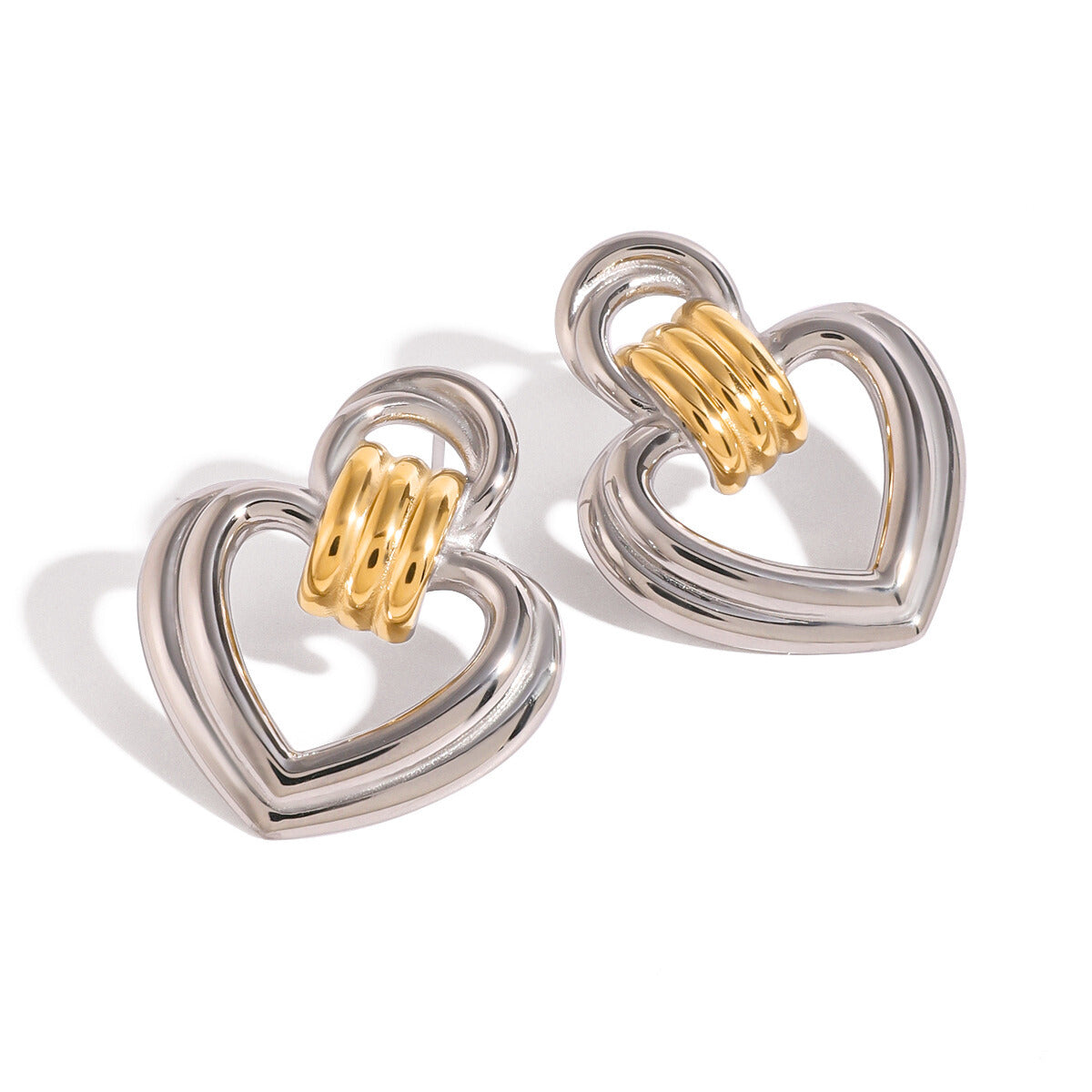 statement heart earrings with silver outline and textured gold center