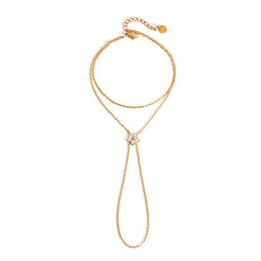 Gold necklace with a floral pendant on a white background