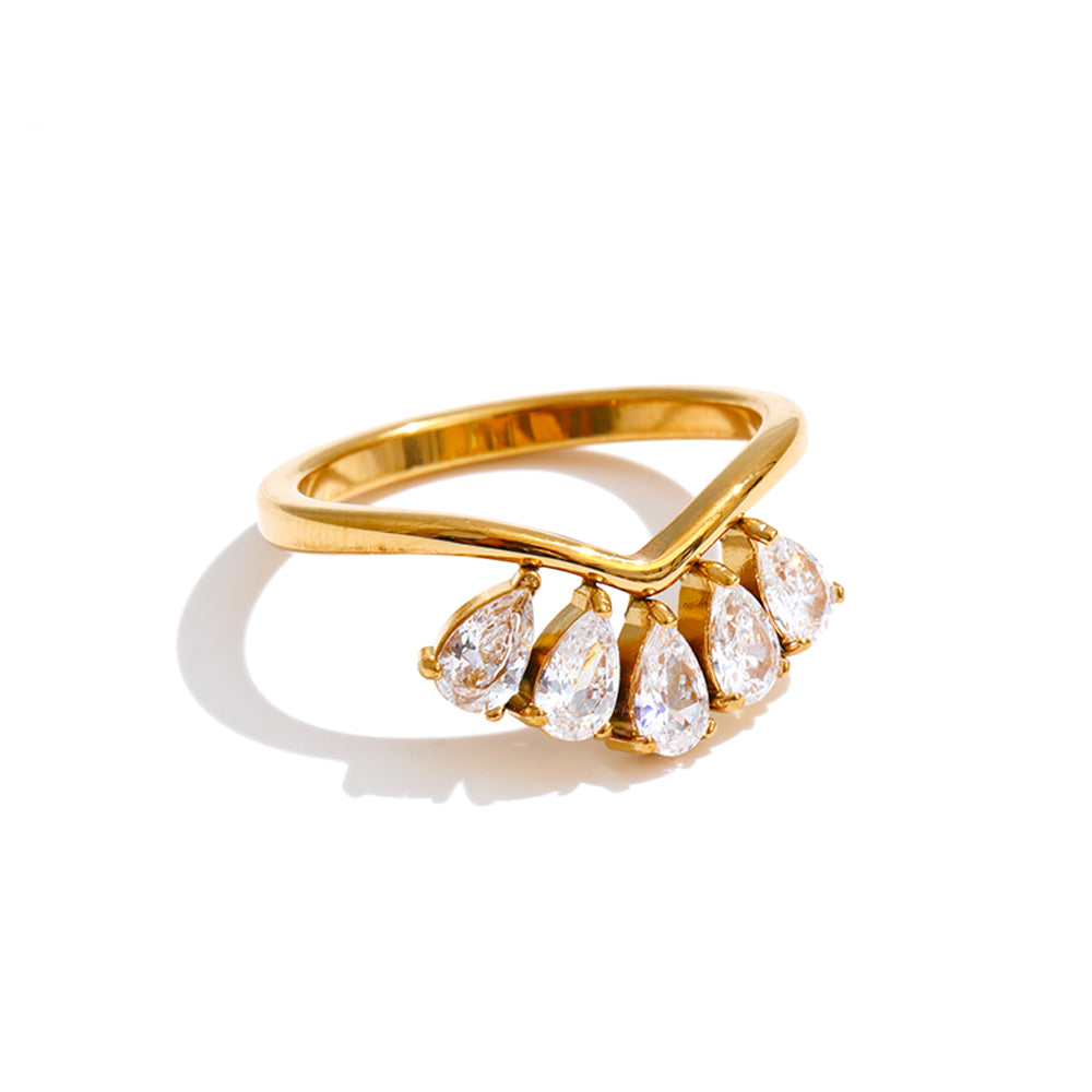 Gold ring with pear-shaped stones on a white background