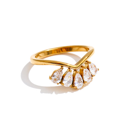 Gold ring with pear-shaped stones on a white background