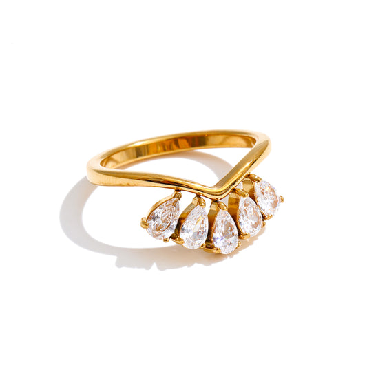 Gold ring with pear-shaped stones on a white background