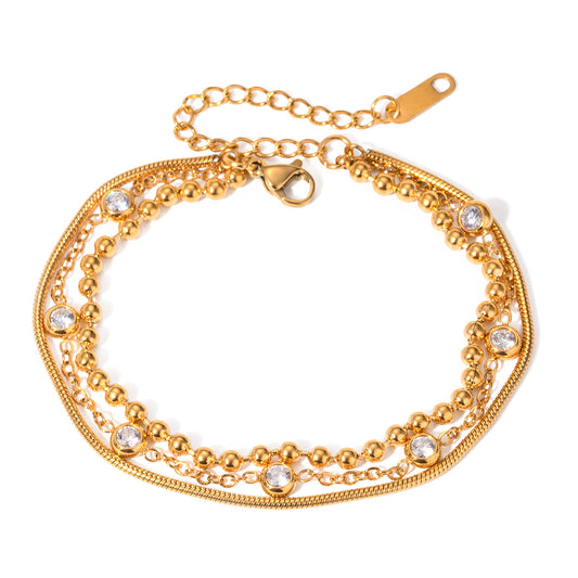 Gold bracelet with multiple chains and crystal embellishments on a white background