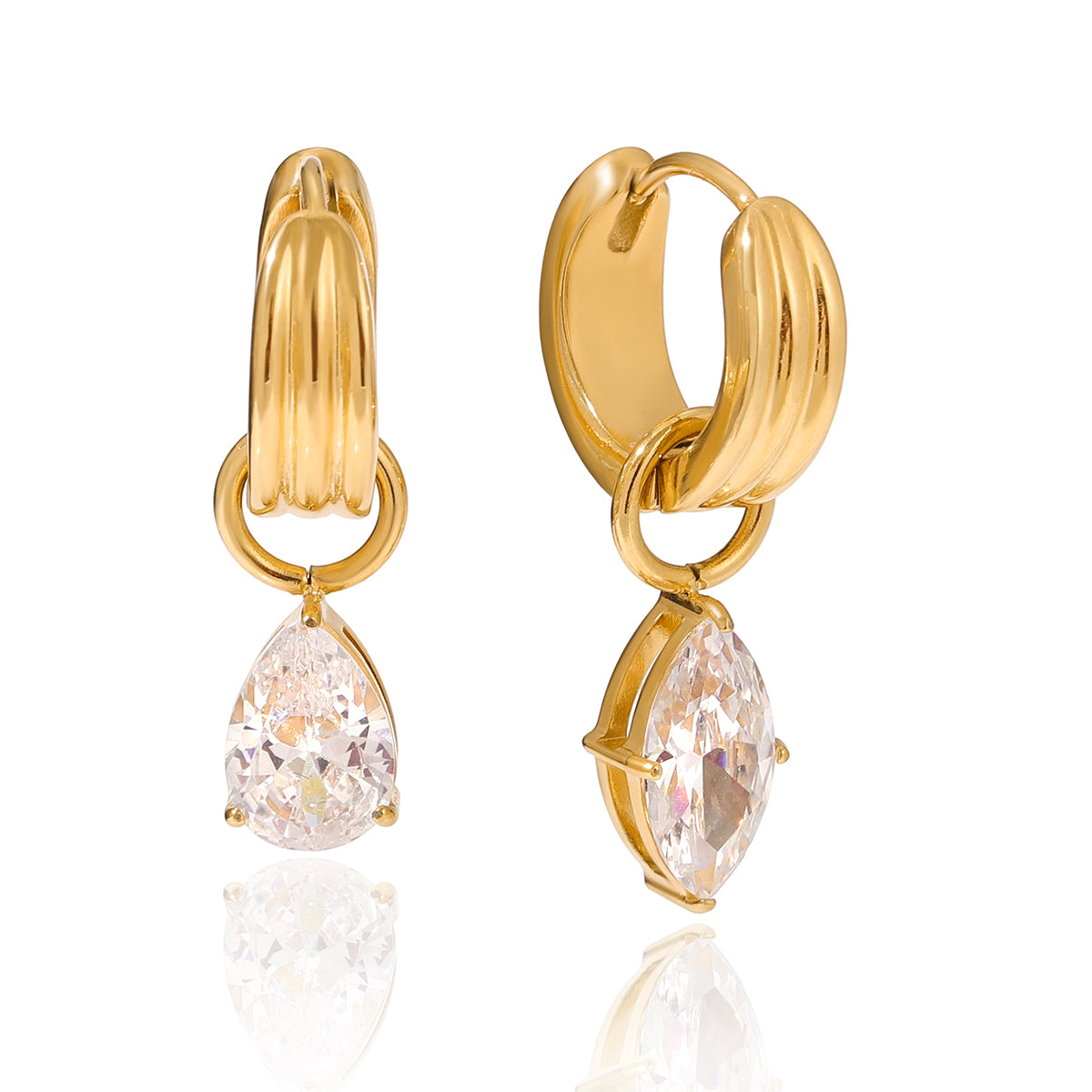 pair of chunky ribbed gold huggie hoop earrings with dangling prong-set pear cut cubic zirconia teardrop charm, click closure, isolated on white background
