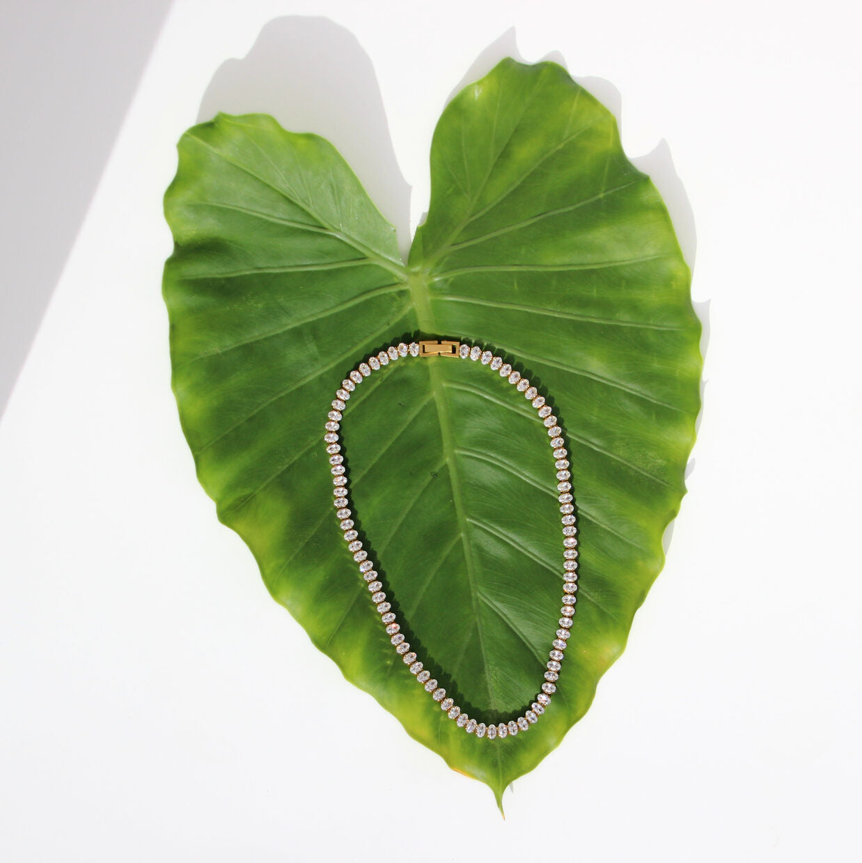 Gold tennis necklace with clear stones and secure clasp
