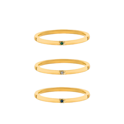 Trio of minimalist gold-plated stainless-steel rings with subtle color and sparkle, perfect for stacking or wearing solo.