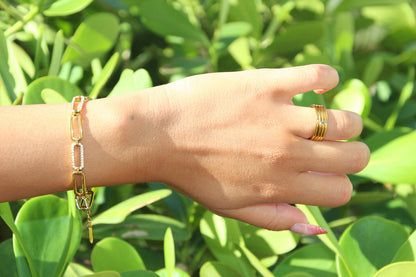 Gold link bracelet with smooth curves and sharp crystal accents
