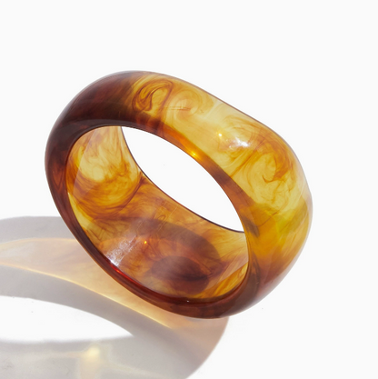 Amayah Jewelry Savanna Resin Bangle Set — three chunky resin bangles in tortoise, white marble, and brown