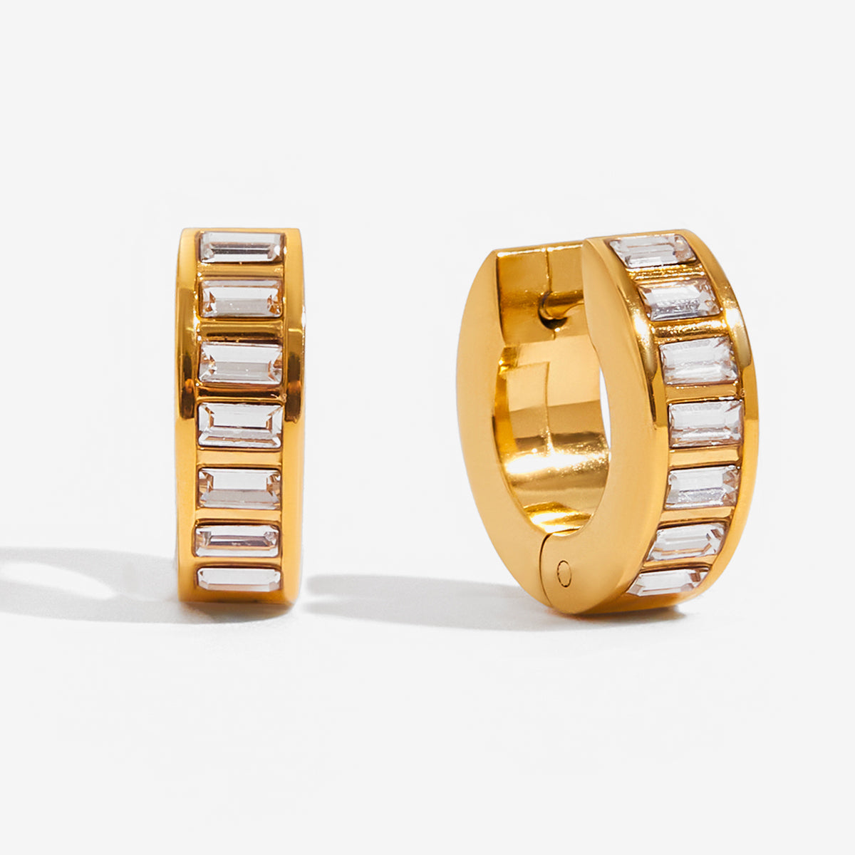 close-up of sofia Hoops gold huggie earring with baguette-cut crystal detailing