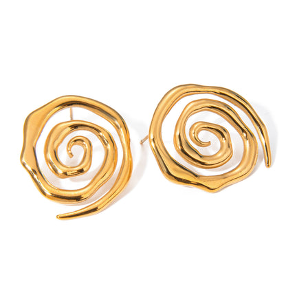 Oversized gold open spiral stud earrings with sculptural swirl design on white background