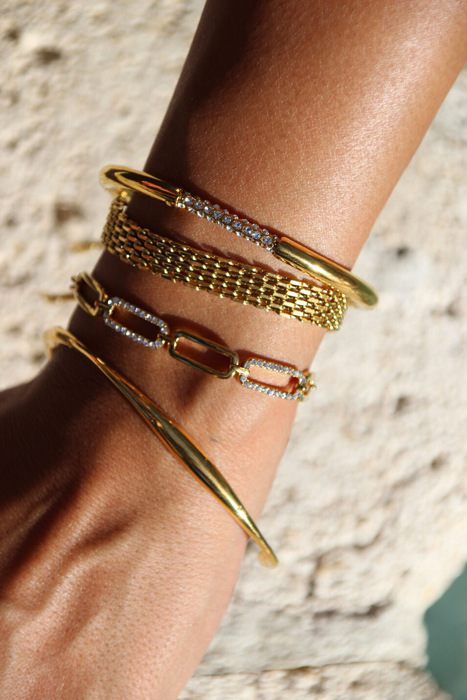 Gold link bracelet with smooth curves and sharp crystal accents