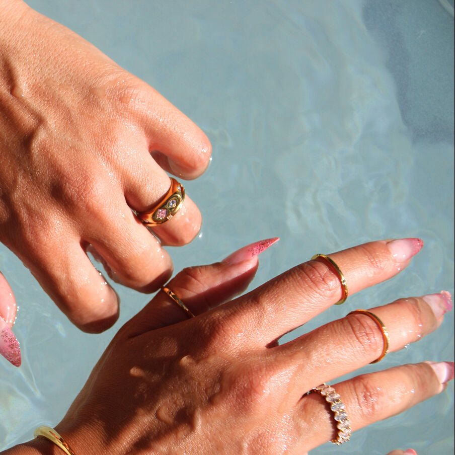 Trio of minimalist gold-plated stainless-steel rings with subtle color and sparkle, perfect for stacking or wearing solo.